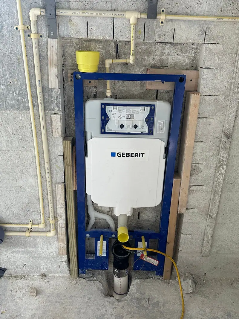 In-wall toilet carrier frame set in a block wall before the finish goes on