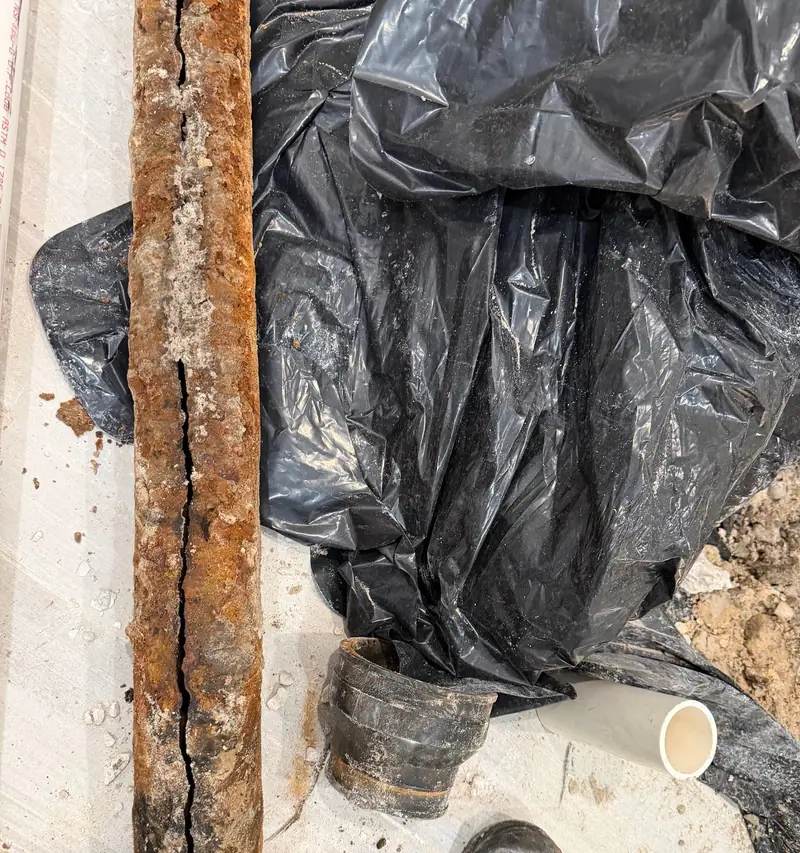 Lengths of rusted old drain pipe pulled out during a repipe
