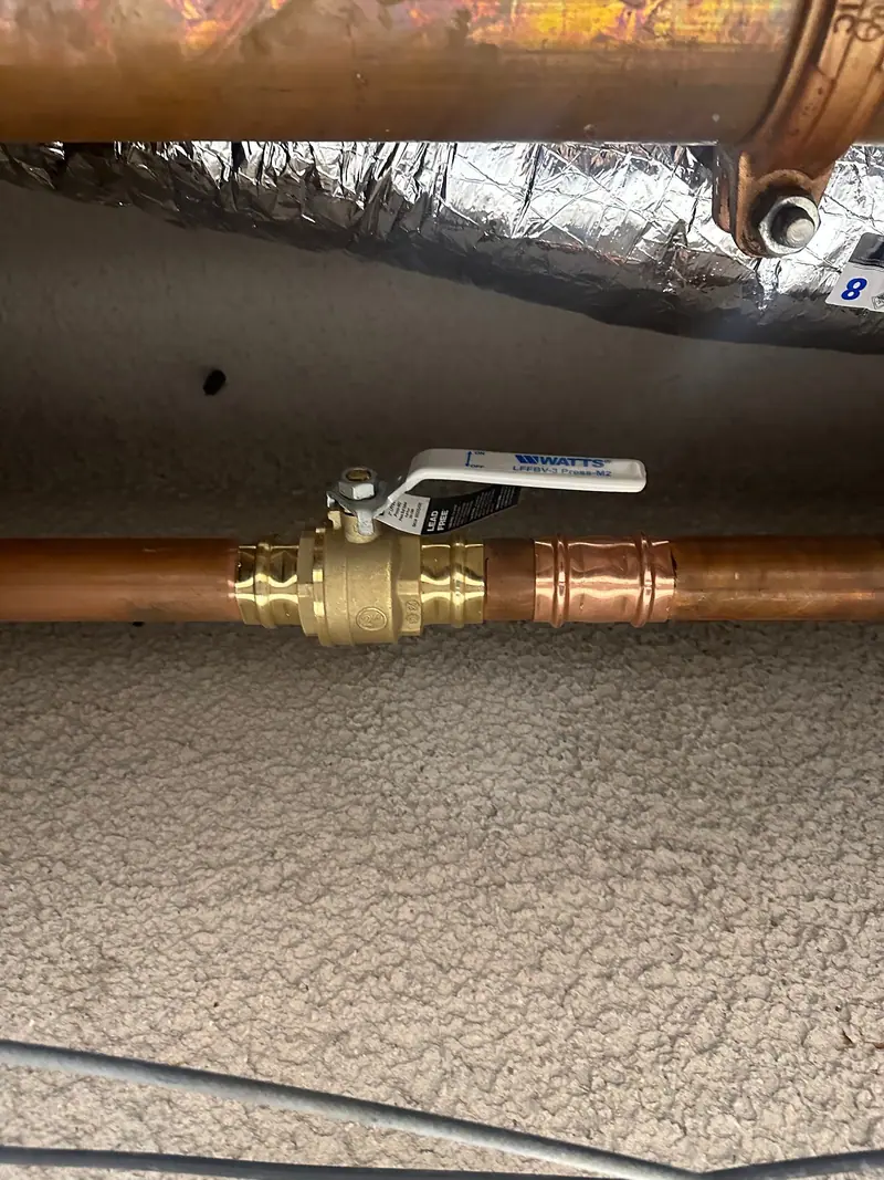 New copper water line with a brass ball valve, installed by Authentic Plumbing Services
