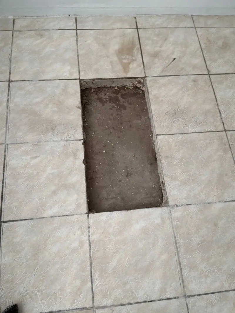 Neat rectangular tile cut-out for slab leak access