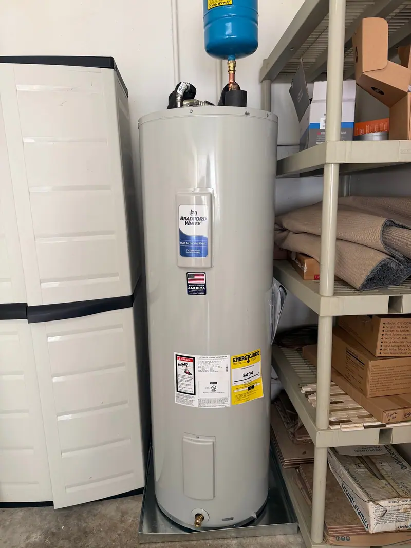 Electric tank water heater with an expansion tank in a garage closet